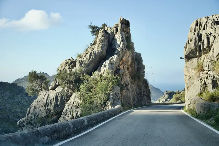 a road with a mountain in the background